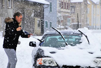 Clearing snow off car